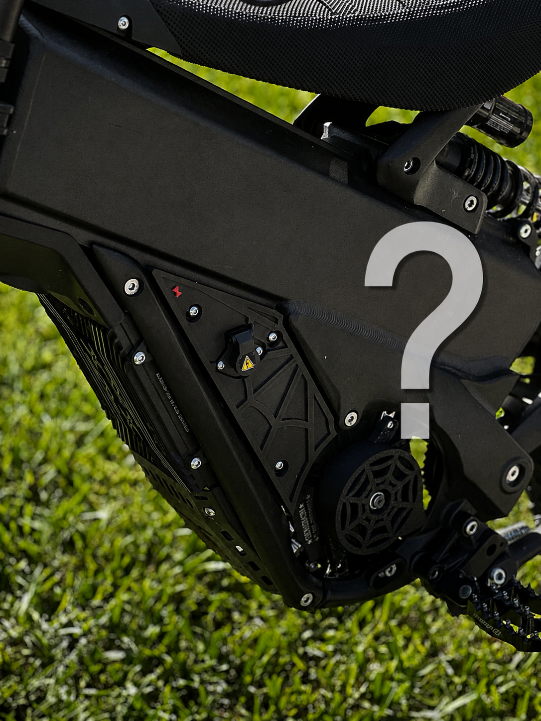 Mystery Plastics - X3A 3D-printed plastics fitted to an electric dirt bike, with a question mark overlay indicating the design is a surprise